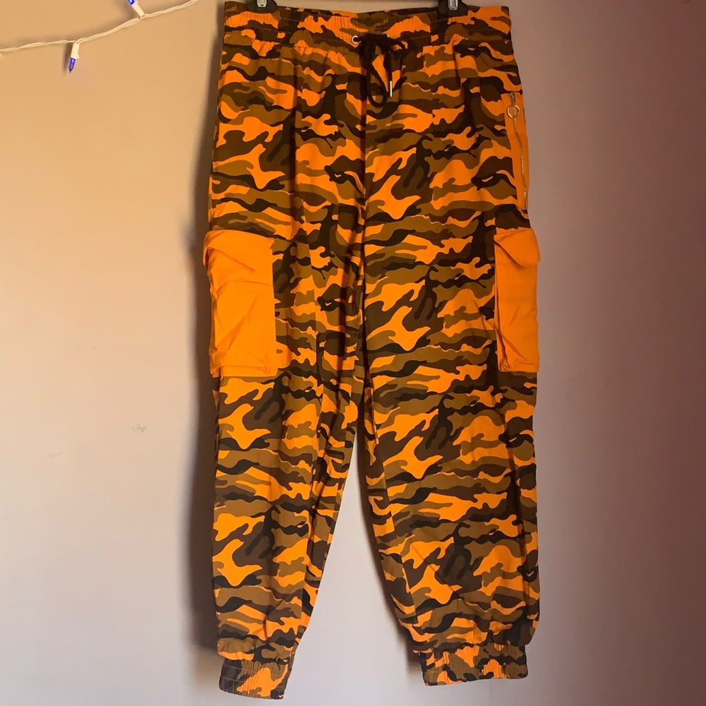 ORANGE CAMO PANTS W/ ELASTIC ANKLES.